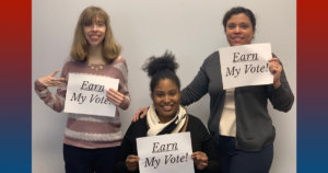 Three RespectAbility team members holding up signs that say "Earn My Vote".