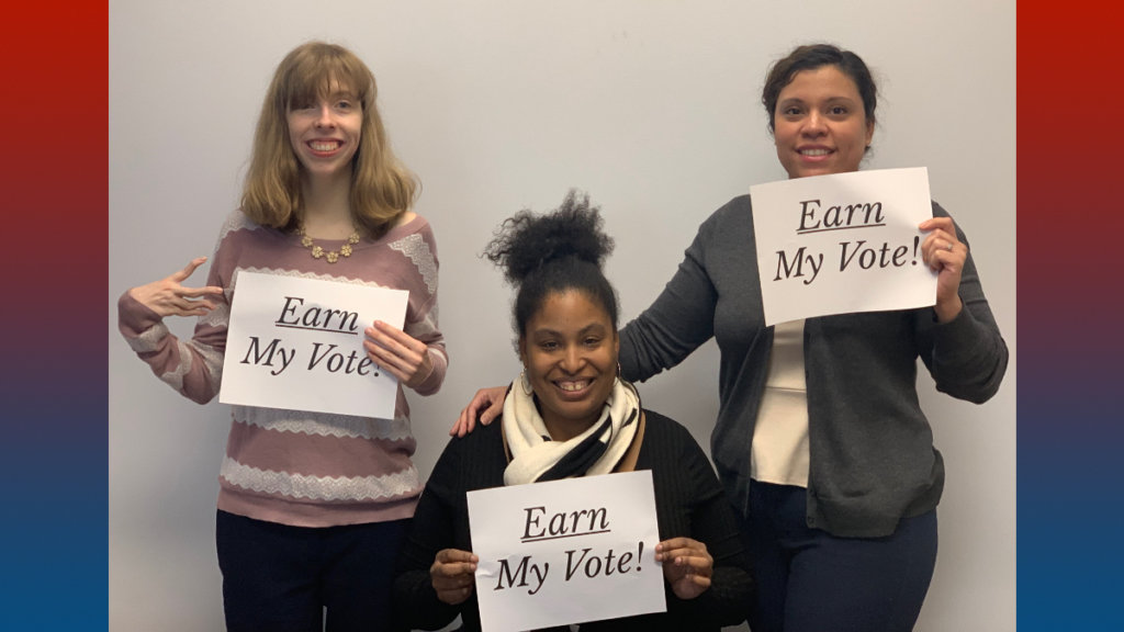 Three RespectAbility team members holding up signs that say "Earn My Vote".