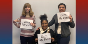 Three RespectAbility team members holding up signs that say "Earn My Vote".