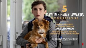 A scene from Healing Powers of Dude with Jace Chapman as Noah holding a dog inside a school. Text: 5 Daytime Emmy Awards Nominations, including Principal Performance in a Children's Program - Jace Chapman, Directing team for a preschool, children's or family viewing program. The Healing Powers of Dude. Netflix icon.