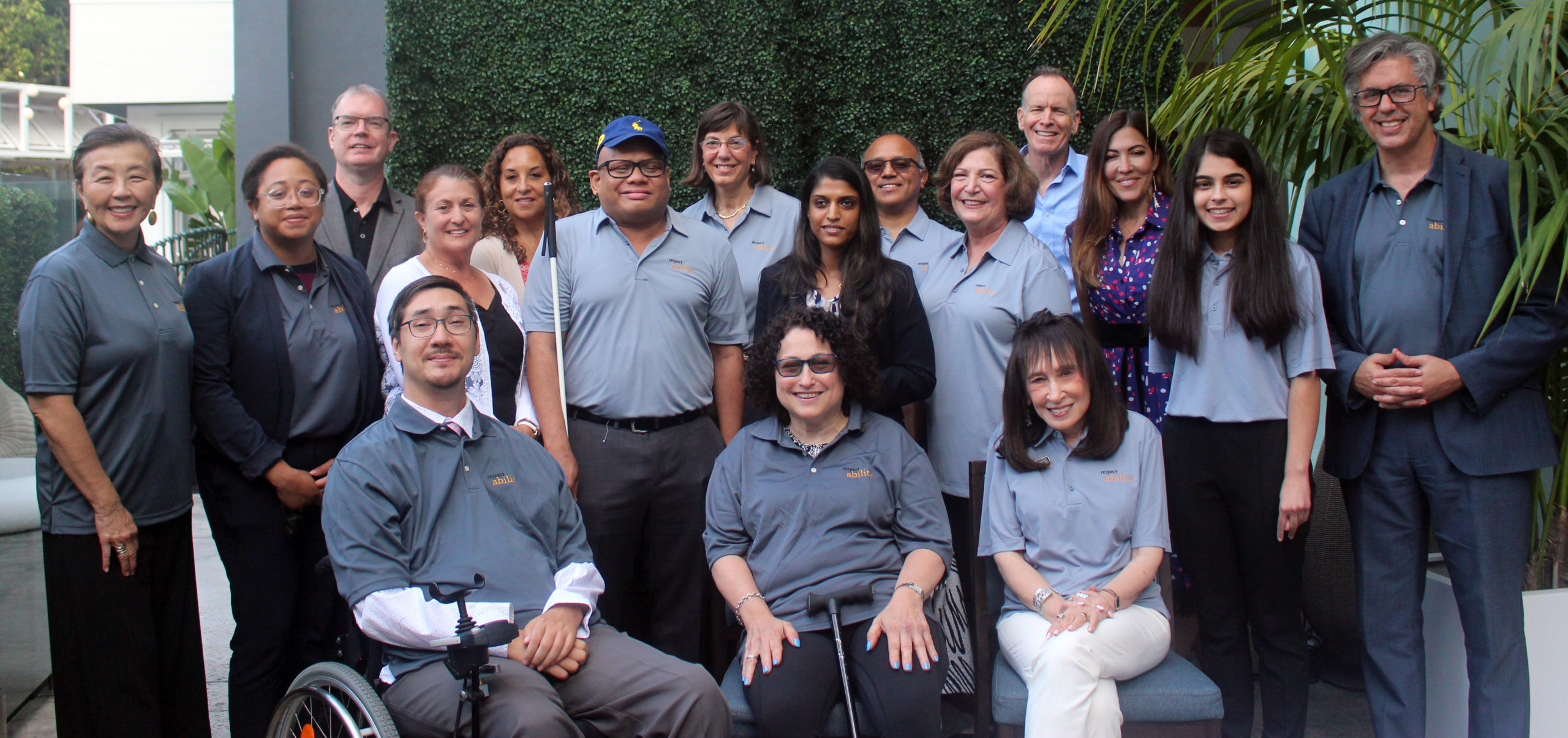 RespectAbility Board members smiling together, many wearing polo shirts with the RespectAbility logo on it