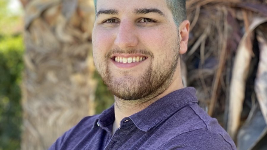 Domenic Vermeulen smiling headshot outside