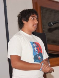 David Sharif giving a speech wearing an Obama Change poster t-shirt