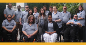 RespectAbility staff members smile together wearing gray polo shirts with the RespectAbility logo on them