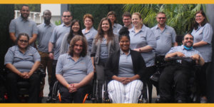 RespectAbility staff members smile together wearing gray polo shirts with the RespectAbility logo on them