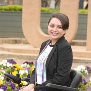 Alejandra Tristan smiling headshot. Tristan is seated in her wheelchair