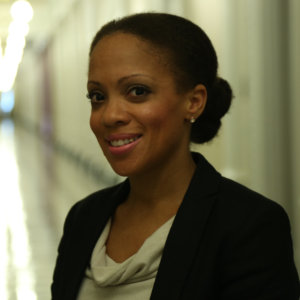 Taryn Mackenzie Williams headshot smiling in a hallway