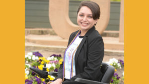 Alejandra Tristan smiling headshot. Tristan is seated in her wheelchair