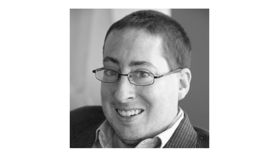 black and white headshot of Justin Chappell smiling