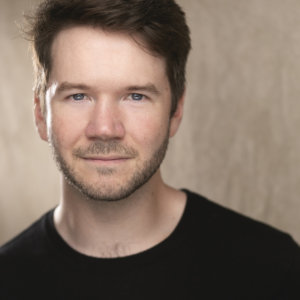 headshot of James Caverly wearing a black shirt