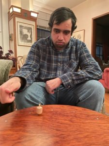 David Sharif playing with a dreidel