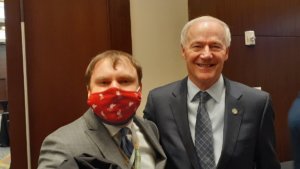 James Trout and Arkansas Governor Asa Hutchinson together wearing suits and ties