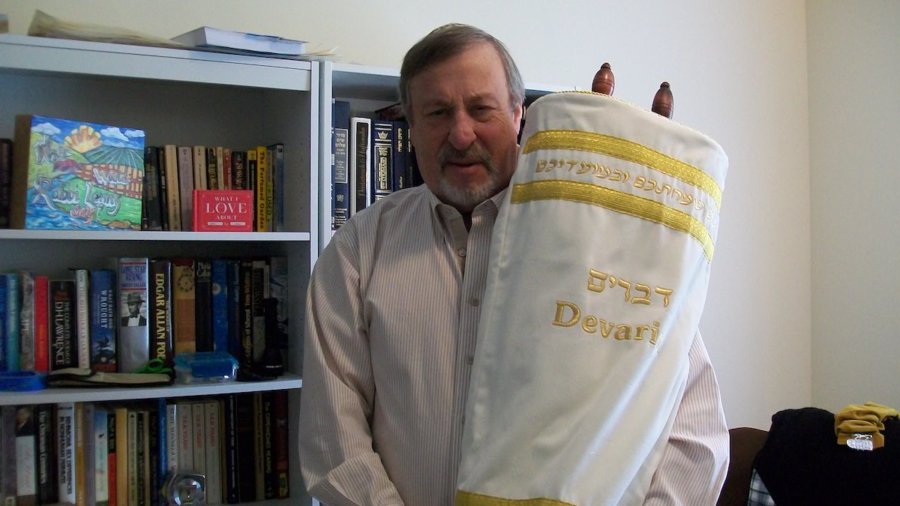 Rabbi Lenny Sarko holding the first ever Hebrew Braille Sefer Torah