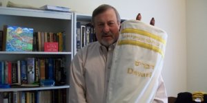 Rabbi Lenny Sarko holding the first ever Hebrew Braille Sefer Torah