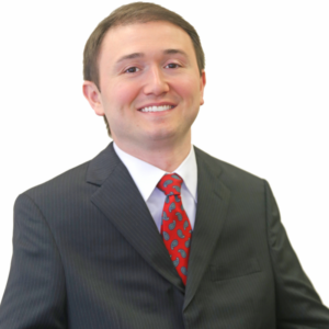 Joshua Basile smiling headshot wearing a suit and tie