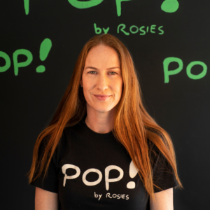 Nechama Chernotsky wearing a t-shirt that says Pop! by Rosies