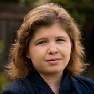 Theresa Soares smiling headshot wearing a blue blazer.