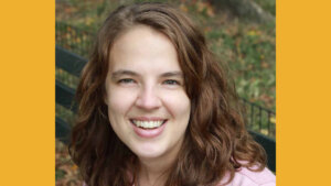 Abigail Shaw smiling seated on a bench outside