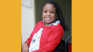 Ketrina Hazell seated in her wheelchair, smiling
