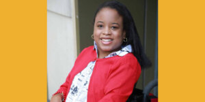 Ketrina Hazell seated in her wheelchair, smiling