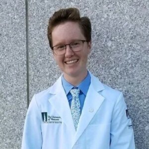 Emerson Wheeler smiling headshot wearing a doctor's jacket