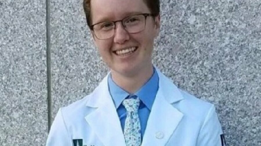 Emerson Wheeler smiling headshot wearing a doctor's jacket