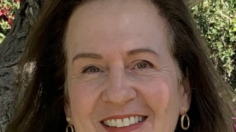 Sharon Swerdlow smiling headshot in front of a tree