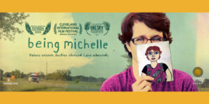 Poster artwork for Being Michelle featuring a woman holding up a paper with a drawing of herself on it, the film's logo, and various awards the film has received.