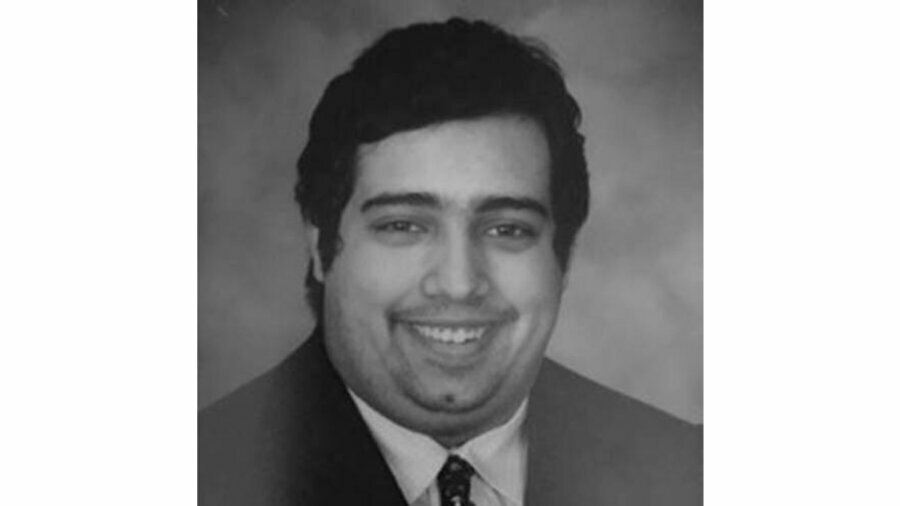 black and white photo of David Sharif wearing a suit and tie