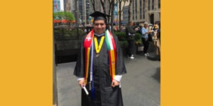 David Sharif wearing his cap and gown after graduating