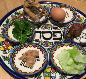 A passover seder plate with food on it.