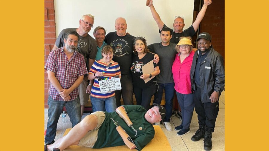 Group photo of the cast and crew behind Taco Tuesday, with John Lawson lying on the floor