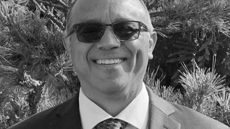 Jaime Pacheco Orozco smiling headshot wearing glasses and a suit and tie