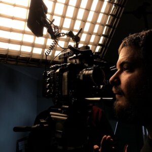David Bornstein on a film set next to a camera