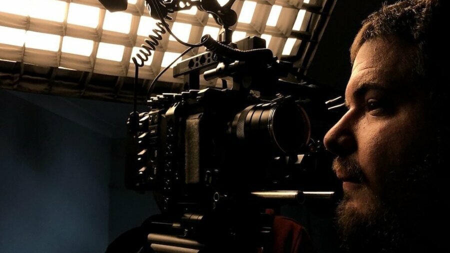 David Bornstein on a film set next to a camera