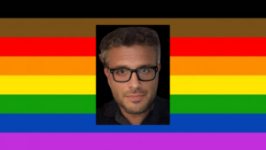 Riccardo Ricciardi headshot. Pride flag as background