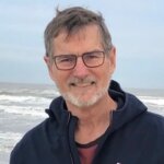 Bill Gaventa smiling in front of the ocean