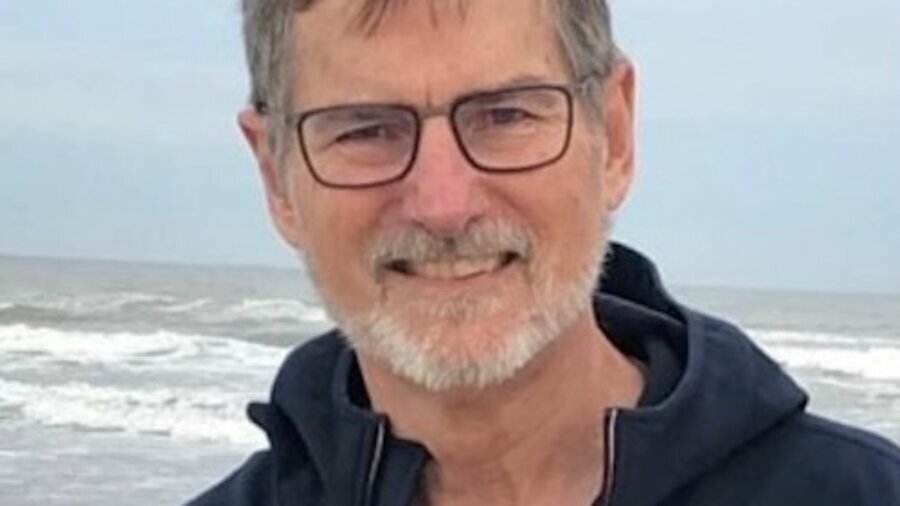 Bill Gaventa smiling in front of the ocean