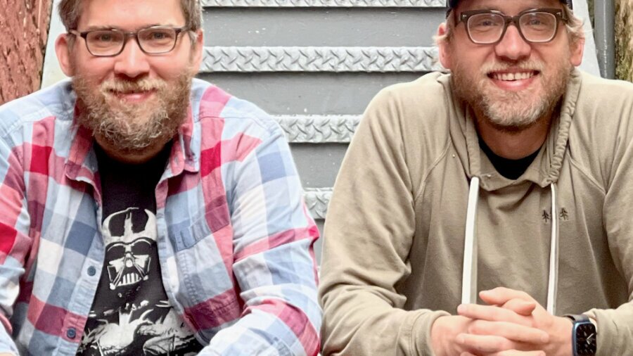 Chris and Charlie Frazier sitting on a staircase