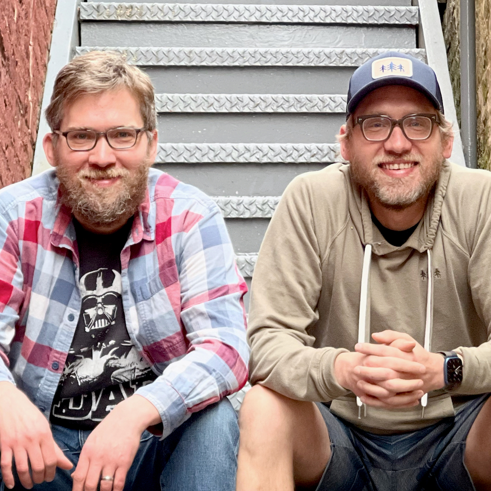 Chris and Charlie Frazier sitting on a staircase