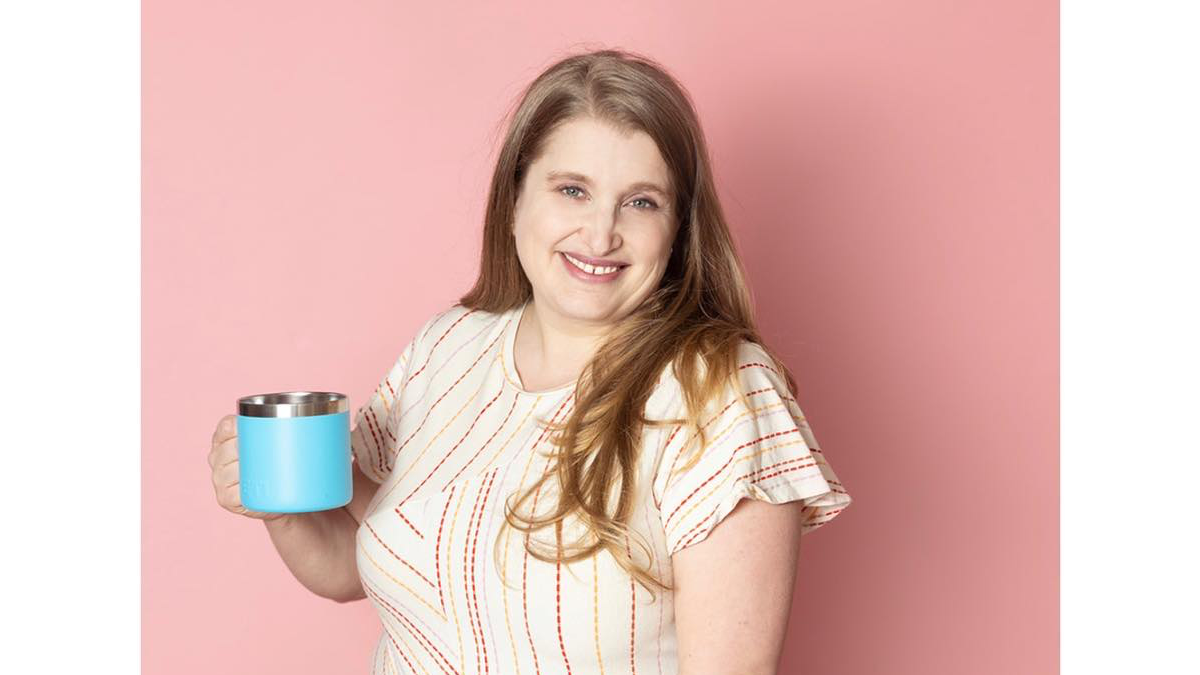 Franki Bagdade smiling holding a mug