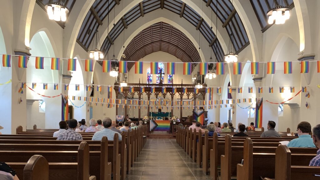 The sanctuary at St. Luke's Church in California decorated with pride flags