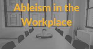 A conference room table in an office with empty chairs around it. Text: Ableism in the workplace.