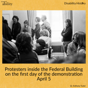 Black and white photo of protesters sitting and standing inside the Federal Building in front of a window. Text: Protesters inside the Federal Building on the first day of the demonstration. April 5. Source: Anthony Tusler.