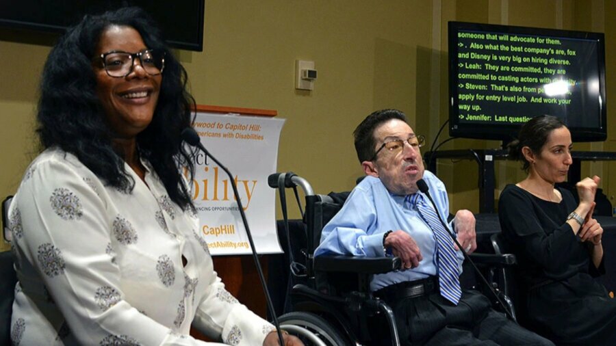 Leah Daniels-Butler and Steven Tingus, along with an ASL interpreter, speaking at a RespectAbility panel in 2017