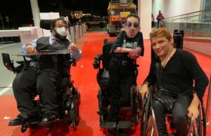 Matan Koch, Steven Tingus, and Andy Arias together on a red carpet event in 2022. All three are wheelchair users.