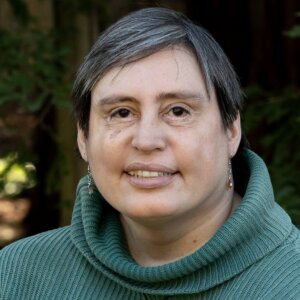 Carey McIntosh smiling headshot wearing a green sweater