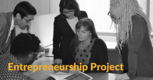 Black and white photo of former RespectAbility fellows looking at a document together around a table. Text: Entrepreneurship Project