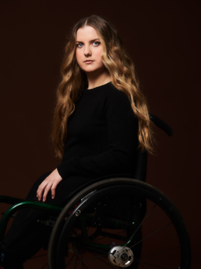 Ella Glendining, director of Is There Anybody Out There, sits in her wheelchair
