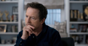 Michael J. Fox with his hand on his chin in a scene from "Still"